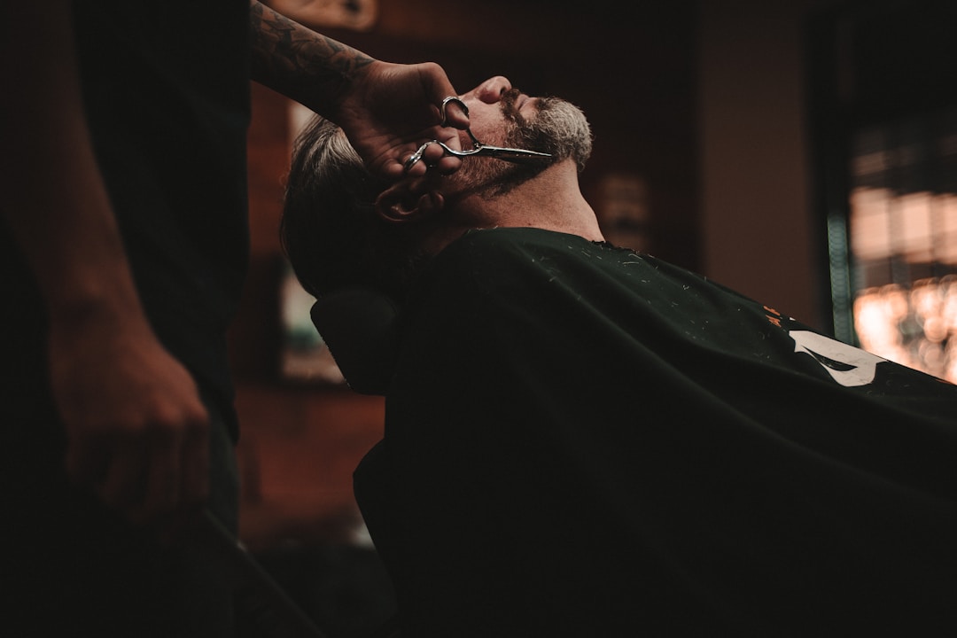 Barber creating seamless transition between low fade and beard