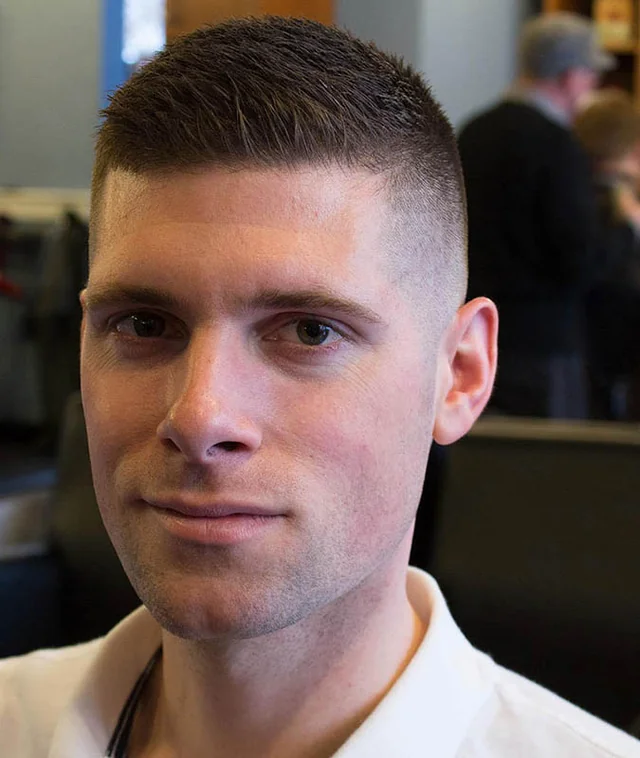 High and tight 2.0 haircut with gradual fade and softer lines showing modern military style evolution