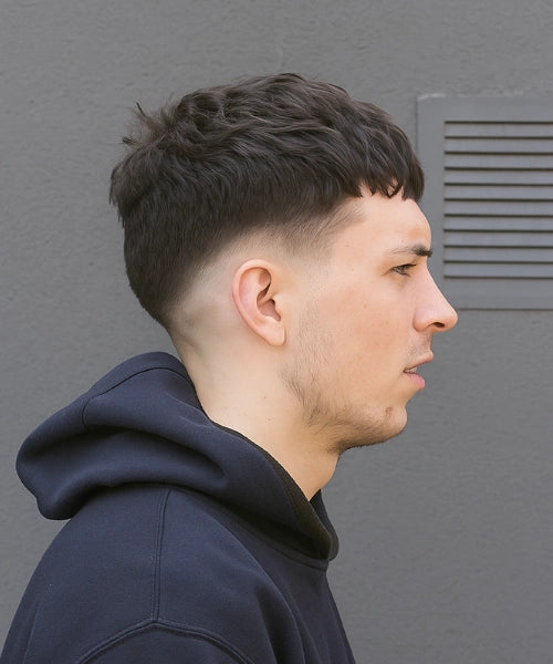 Low Caesar crop fade with gradual blend starting at ears mens Queens 2026