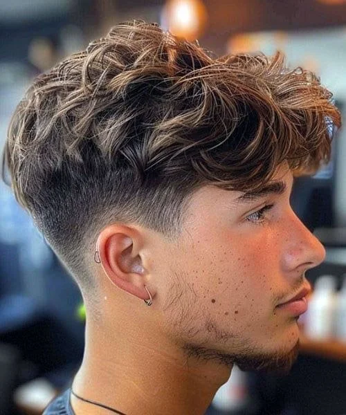Low fade with textured top | modern mens haircut featuring low fade sides with choppy textured styling on top