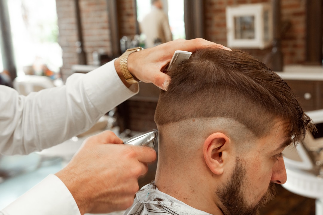 Professional barber creating precise fade haircut