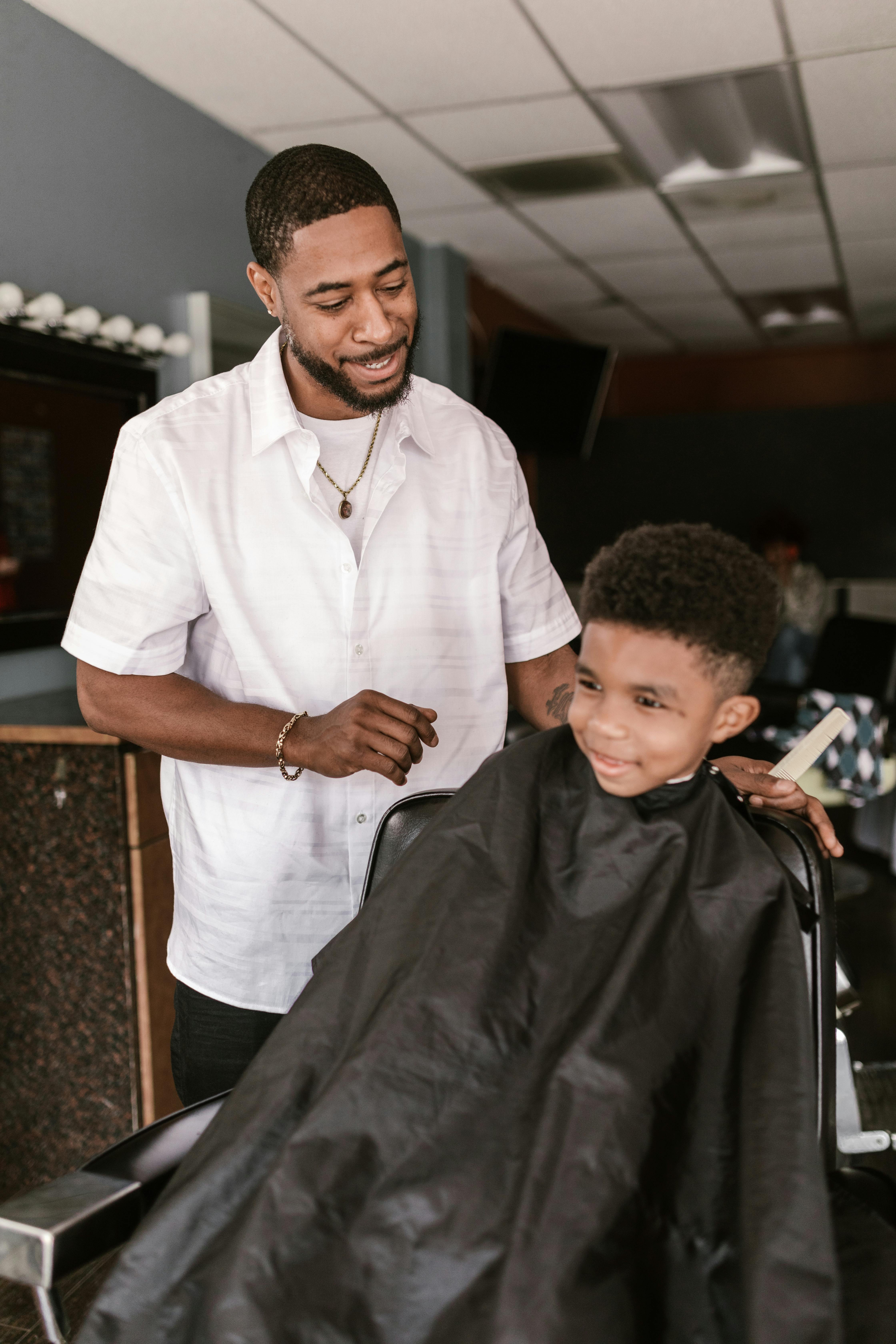 Professional barber providing friendly service to young child at DIDA Hair Studio